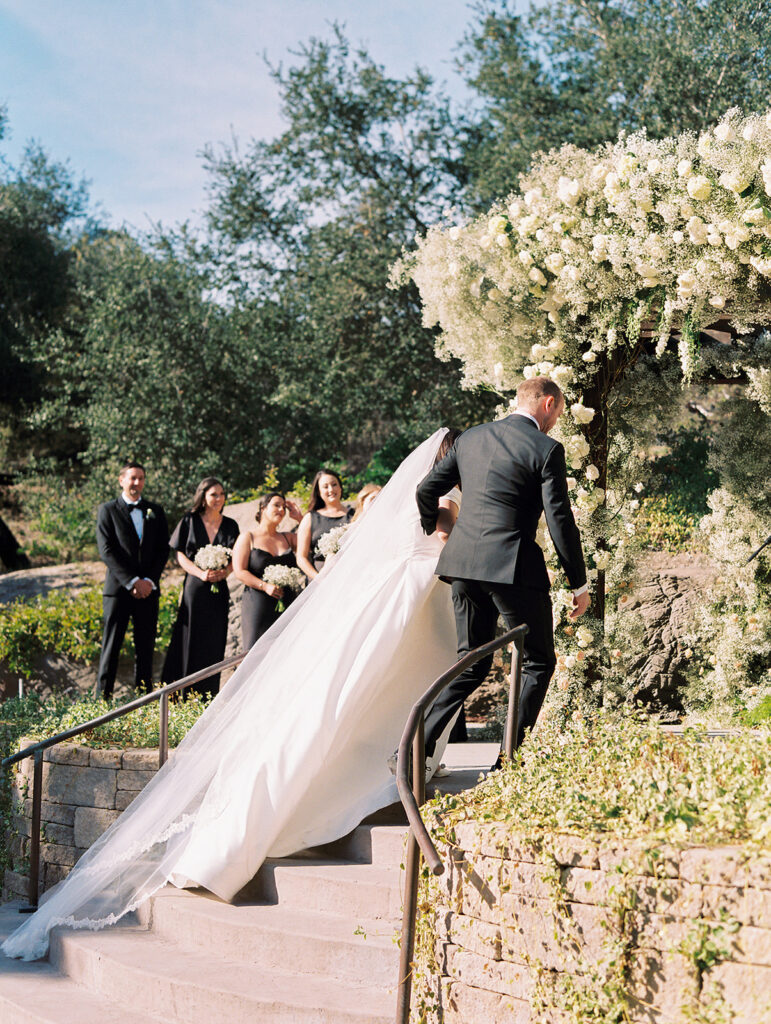 Large wedding ceremony arch made with babies breath flowers and white roses at Villa Loriana