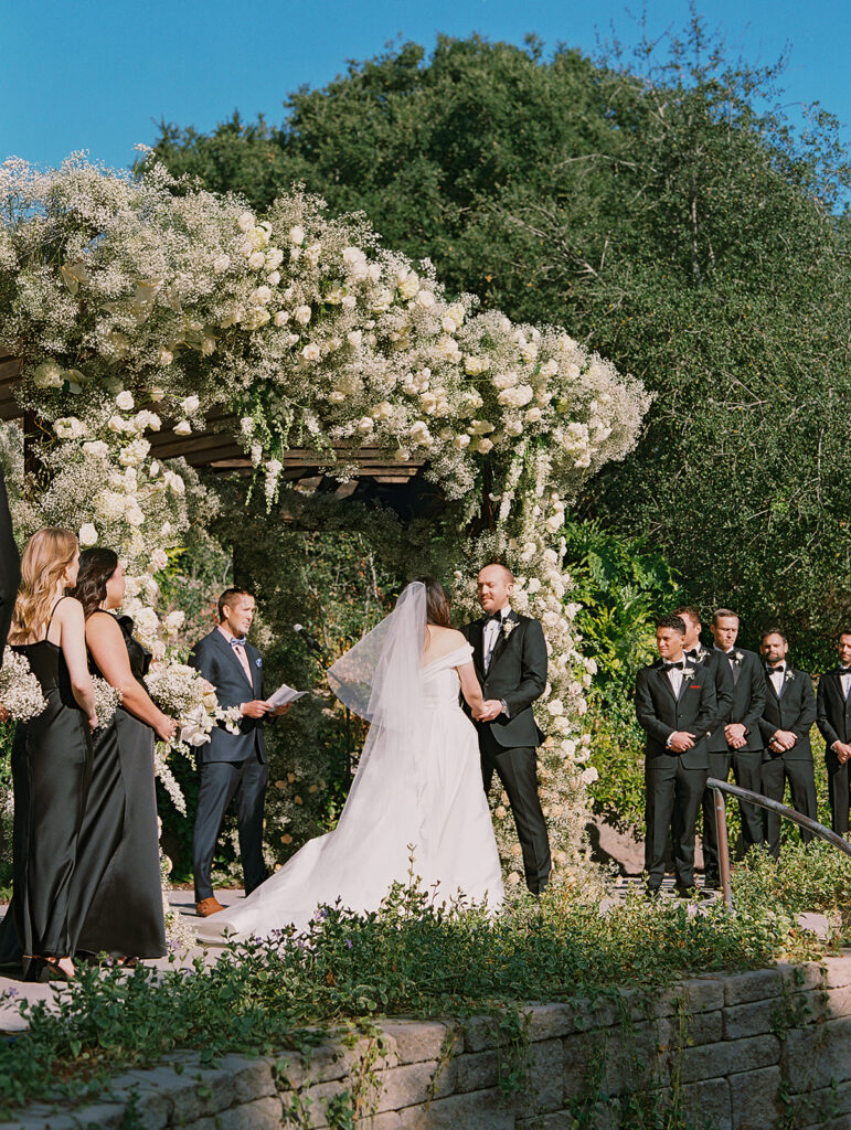 Large wedding ceremony arch made with babies breath flowers and white roses at Villa Loriana