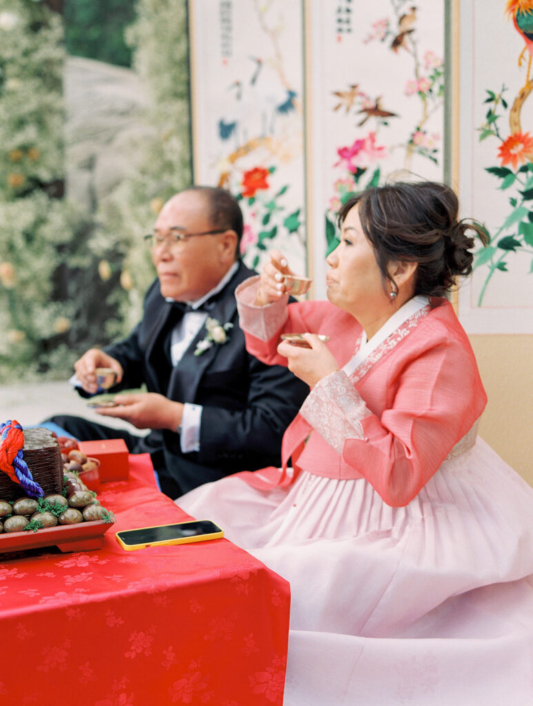 Korean wedding Tea Ceremony with bride and groom in traditional attire.