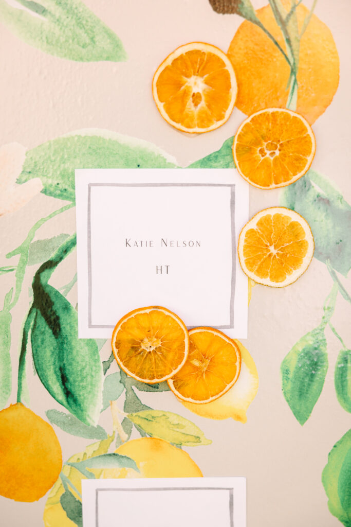 Wedding seating chart. Orange patterned escort card display wall.