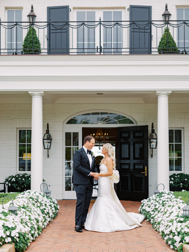 Bride and groom portrait in front of the Rosewood Miramar Beach