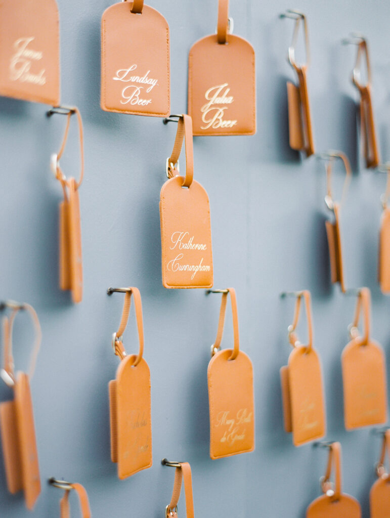 Wedding seating chart with leather luggage tags at the Rosewood Miramar Beach resort