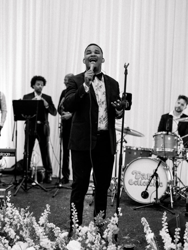 Black and white photo of Dart Collective band playing in the Rosewood Miramar Beach Resort Ballroom for a wedding reception.