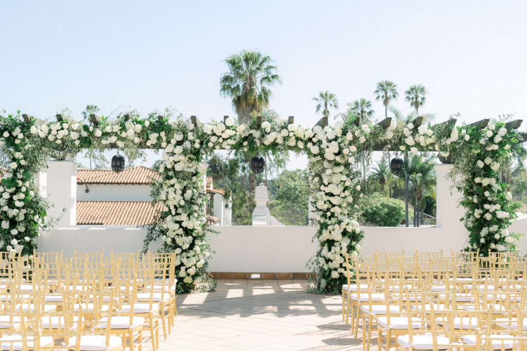 Triple wedding arch at Hotel Californian Sirena Rooftop with white flowers