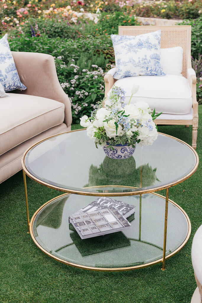 Coffee table at outdoor wedding with small floral centerpiece and coffee table books