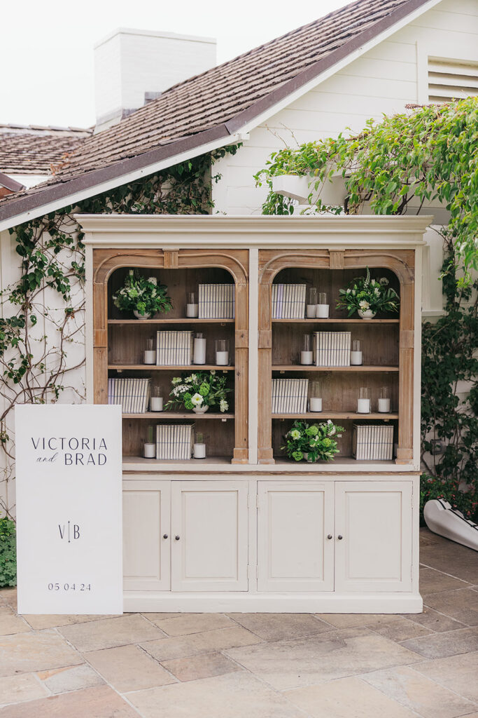 Wedding Escort card display using a bookshelf and custom journals for guests