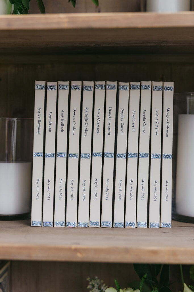 Wedding Escort card display using a bookshelf and custom journals for guests with candles