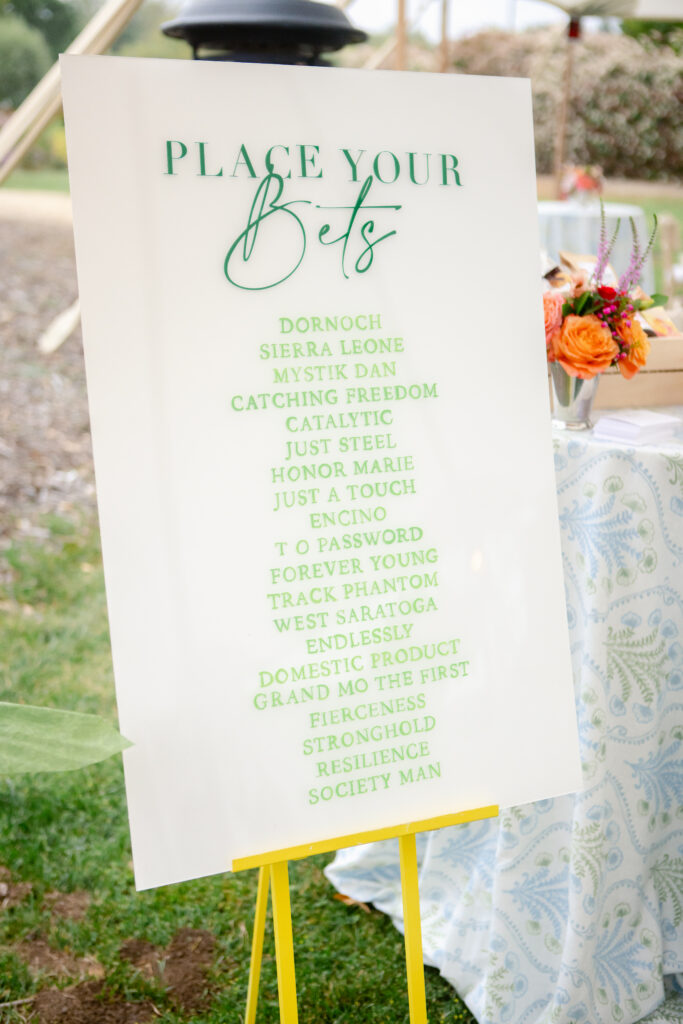 White event sign with green words for "Placing Your Bets" on Kentucky Derby race horses. Names of horses listed.