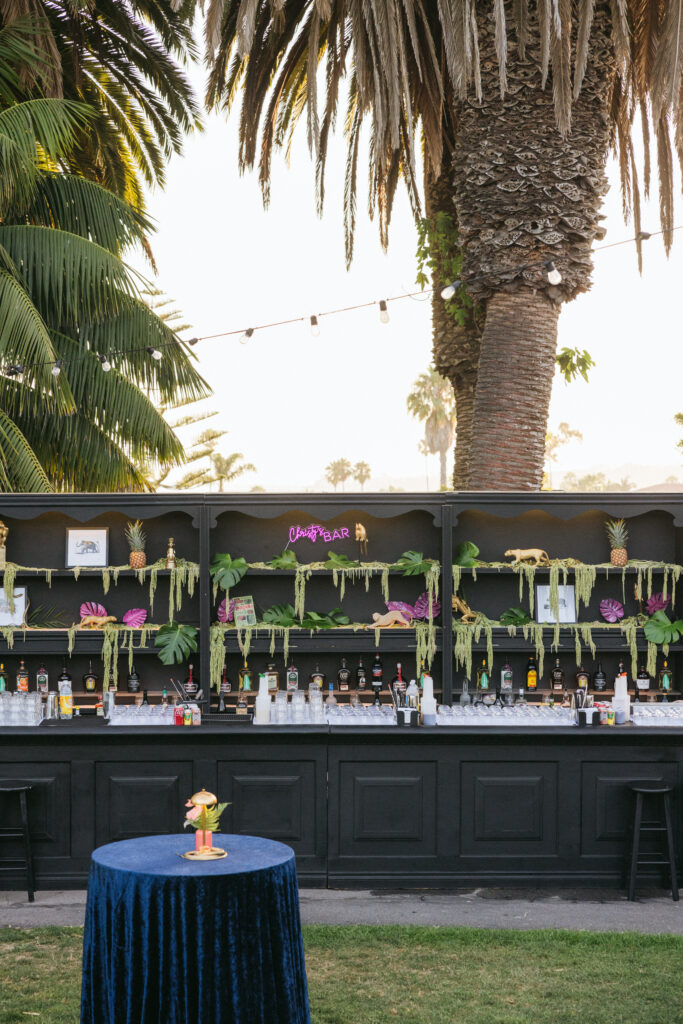 Black bar with decorated shelves for jungle themed party