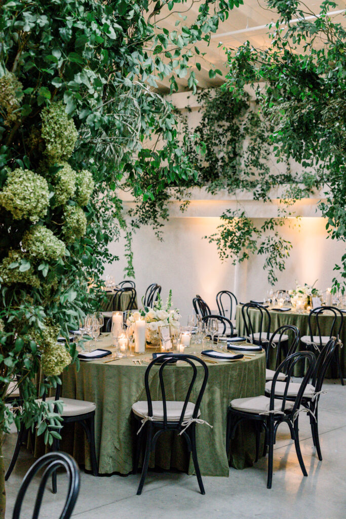 Wedding reception at Greengate Ranch & Vineyard overflowing with greenery and chandeliers