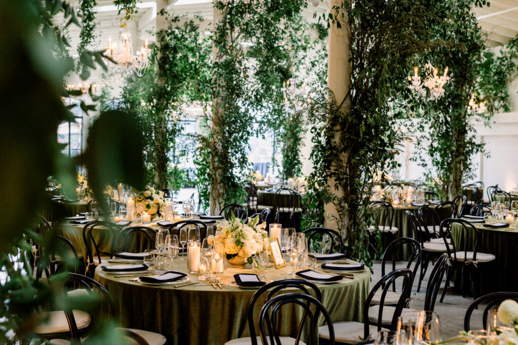 Wedding reception at Greengate Ranch & Vineyard overflowing with greenery and chandeliers