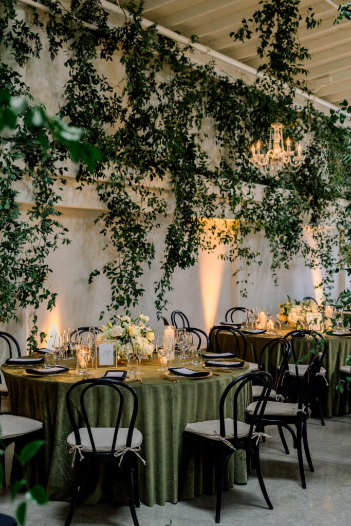 Wedding reception at Greengate Ranch & Vineyard overflowing with greenery and chandeliers