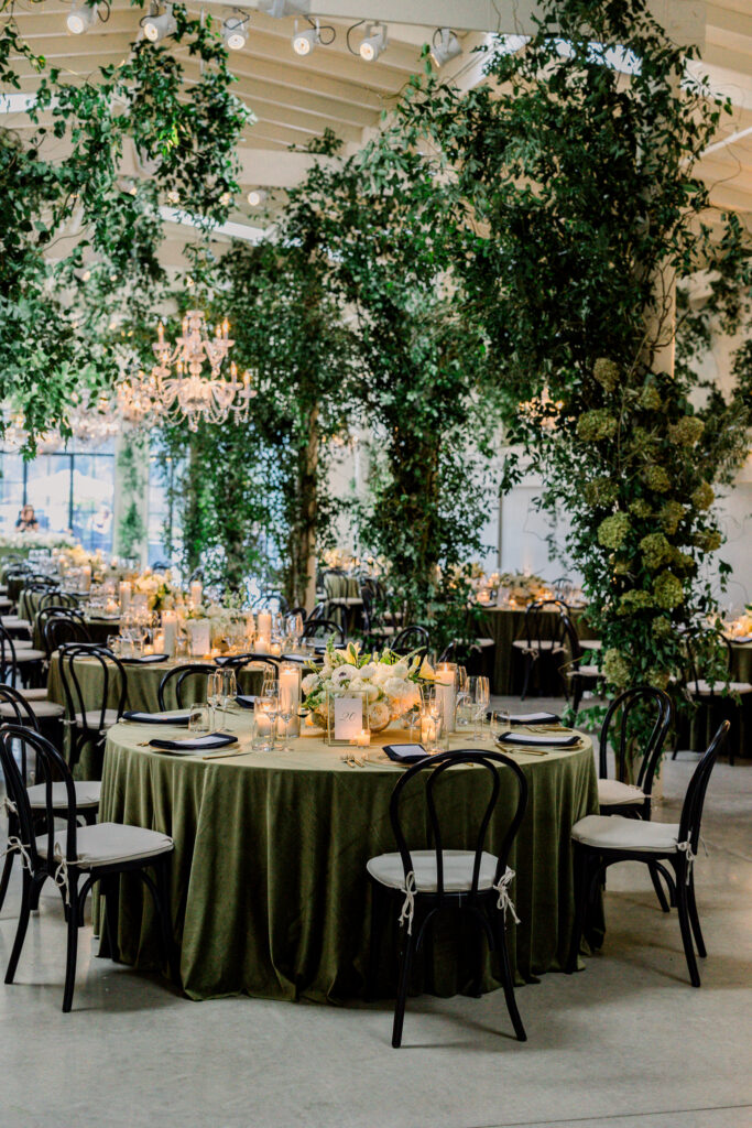 Wedding reception at Greengate Ranch & Vineyard overflowing with greenery and chandeliers