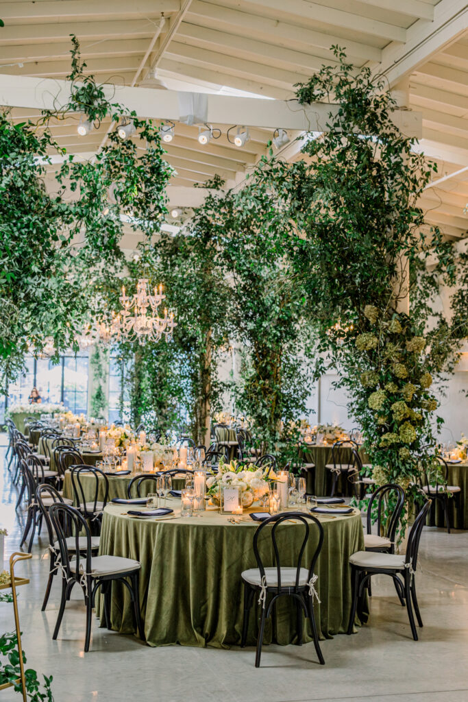Wedding reception at Greengate Ranch & Vineyard overflowing with greenery and chandeliers