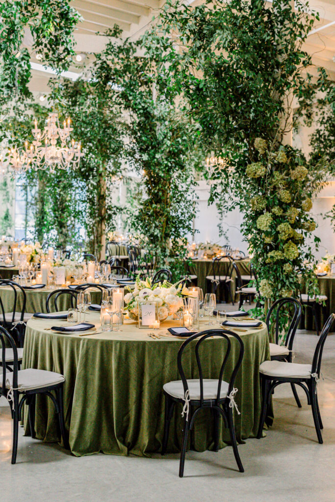 Wedding reception at Greengate Ranch & Vineyard overflowing with greenery and chandeliers
