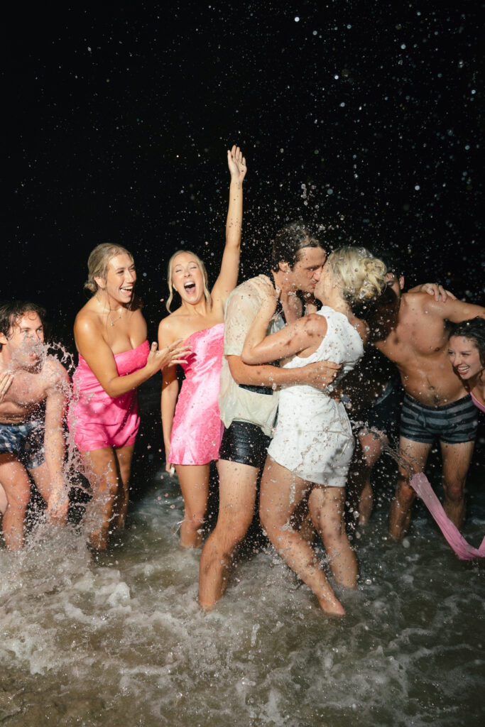 wedding party in ocean for dip after wedding