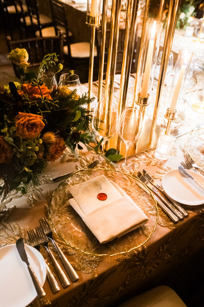 Corporate Holiday party tablescape with gold sequin linens