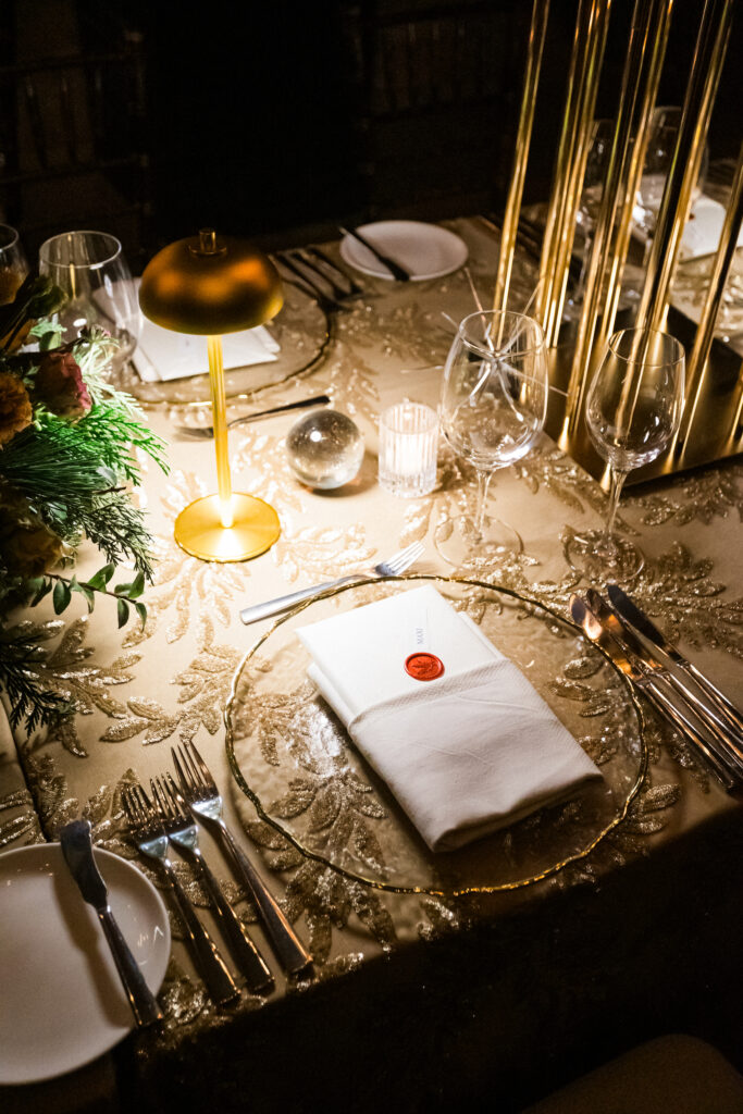 Corporate Holiday party tablescape with gold sequin linens