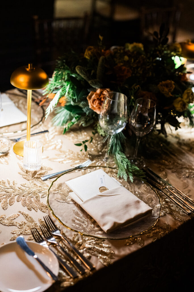 Corporate Holiday party tablescape with gold sequin linens